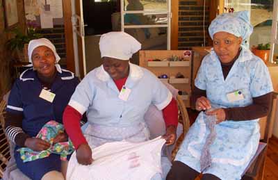 Three ladies practising mending